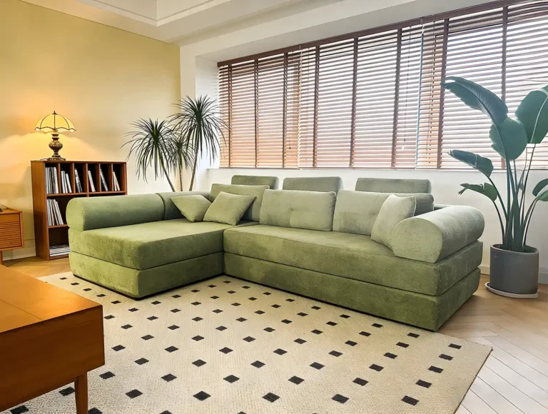 Sage green boucle L-shaped modular sofa - retro cozy design for warm living rooms